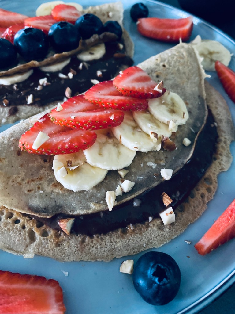 Buckwheat Pancakes with Chocolate Sauce and Fruits and Berries